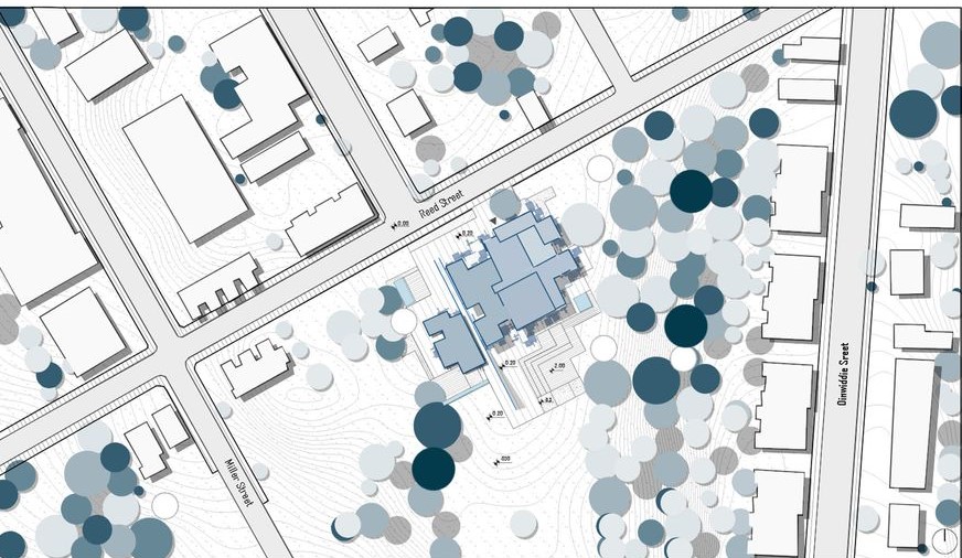 Site plan: Office building with landscaping and surrounding streets.