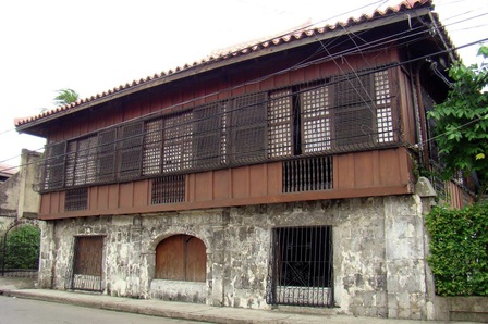 An image of an old bahay na bato building with a geometric style.
