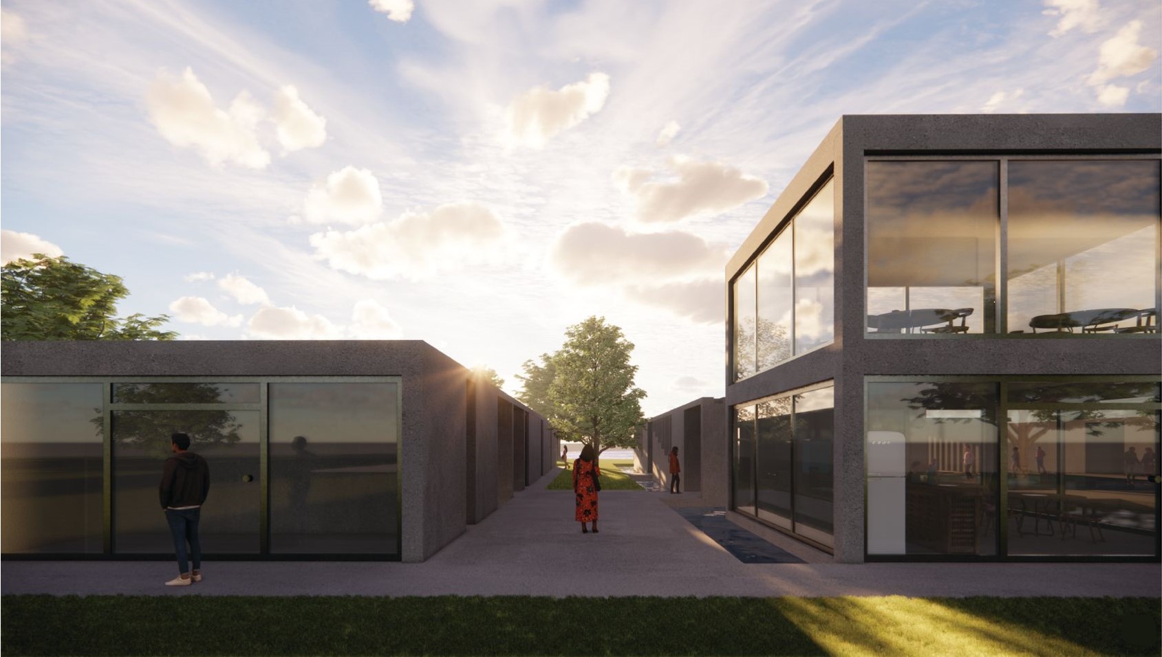 Main entrance with glass facades reflecting nature.