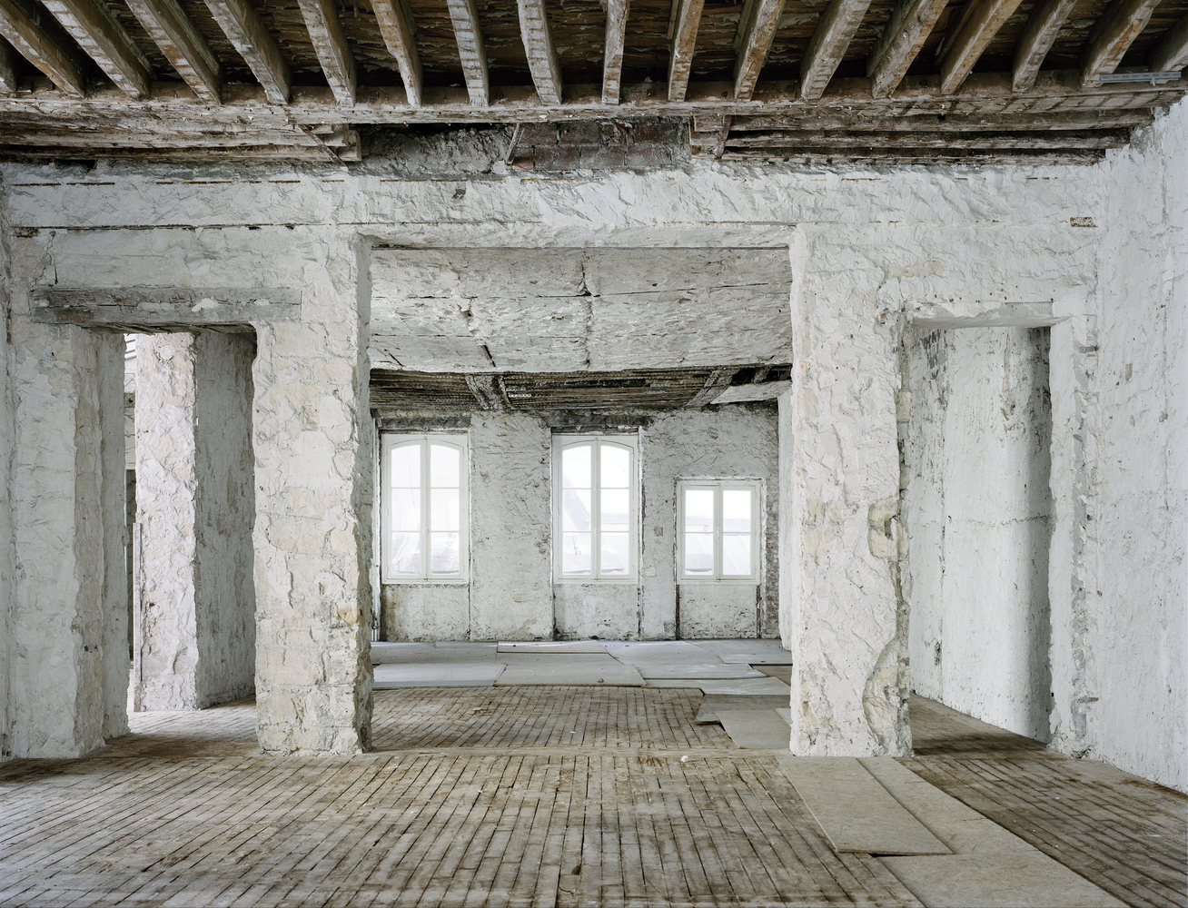 Before: thick masonry walls, timber joists above, three windows, exposed rubble