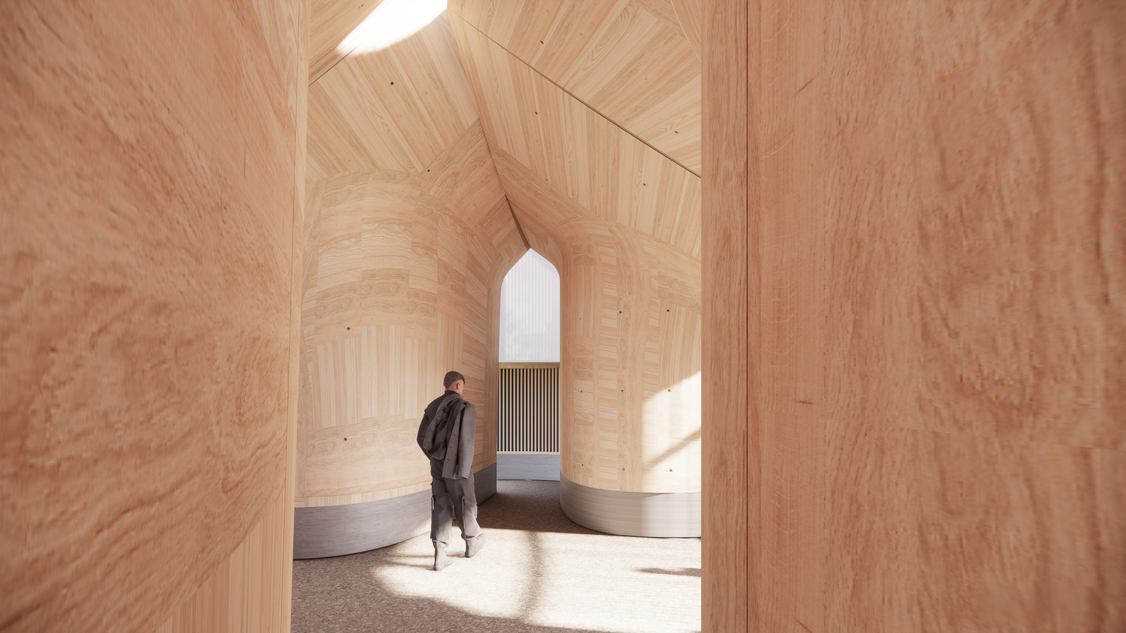 Interior with curved plywood walls and vaulted ceiling with narrow skylight illuminating a figure in shadow
