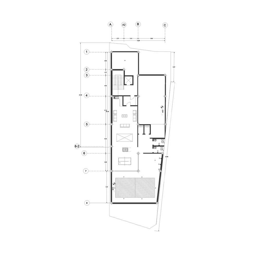 Ground floor plan drawing showing living spaces and a rear courtyard on an angled lot