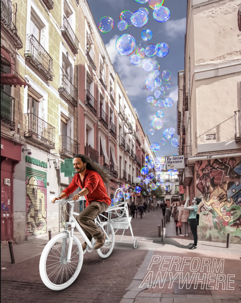 Madrid street scene: a cyclist rides down a narrow lane trailing a cloud of iridescent soap bubbles overhead, with the tagline PERFORM ANYWHERE at the bottom