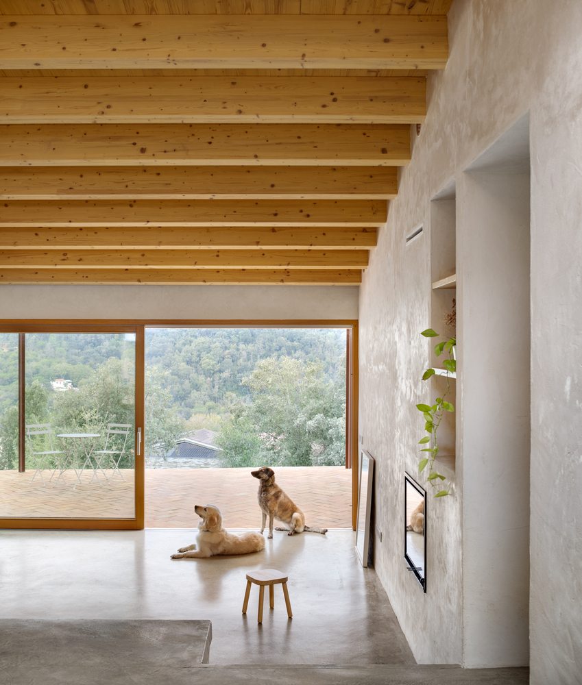 Terrace view: metal bistro furniture, misty mountains, trees, morning light