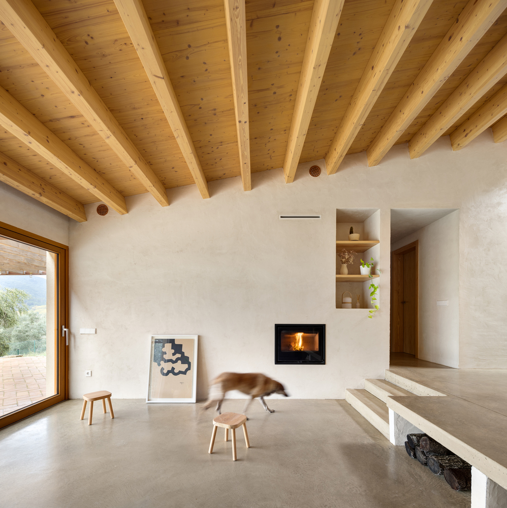 Bedroom: timber beam ceiling, oak sliding doors to corridor, bed with knit throw, framed art