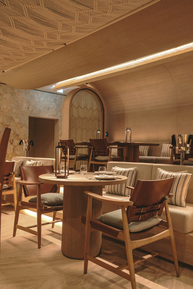 Nalu dining: intimate booth with woven timber ceiling vault, timber table, upholstered seating