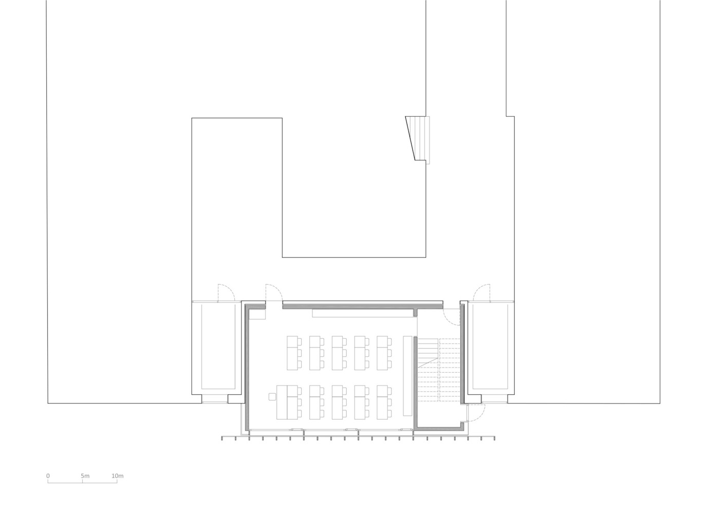 First-floor plan: the extension detail showing two classrooms with desks, changing room, and stair