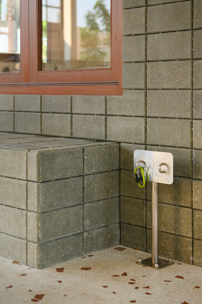 Base detail: concrete block plinth meeting terrazzo floor tiles with coloured aggregate