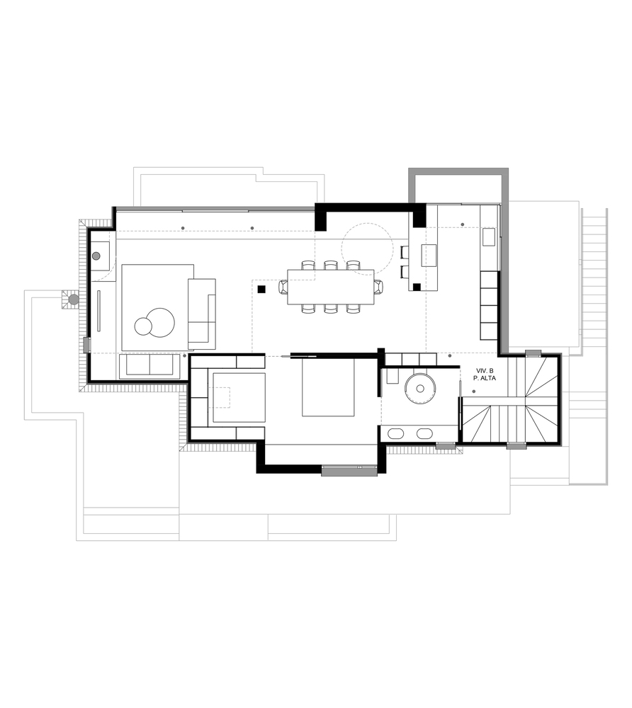 Floor plan drawing showing open living and dining spaces with spiral staircase