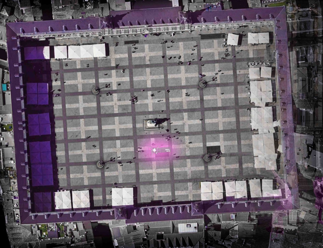 Aerial plan of the Tensegrity Blackbox deployed across Plaza Mayor: a purple-lit structural grid covers the entire square, with white event tents, gathering crowds, and a glowing magenta focal point at the centre