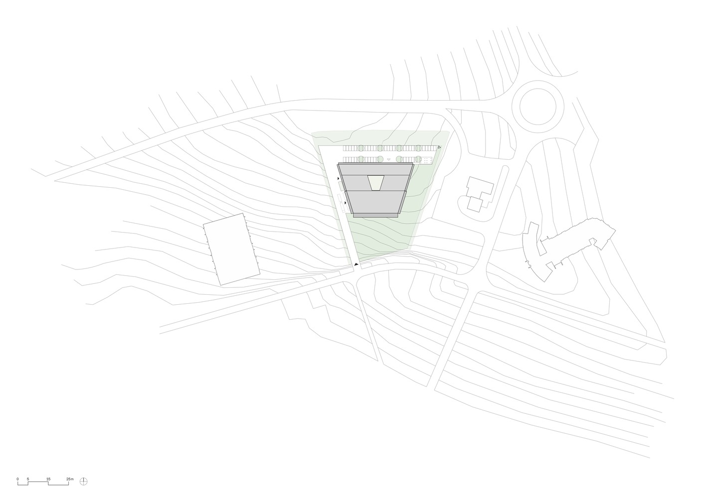 Site plan drawing showing the angular building footprint with topographic contours and access roads