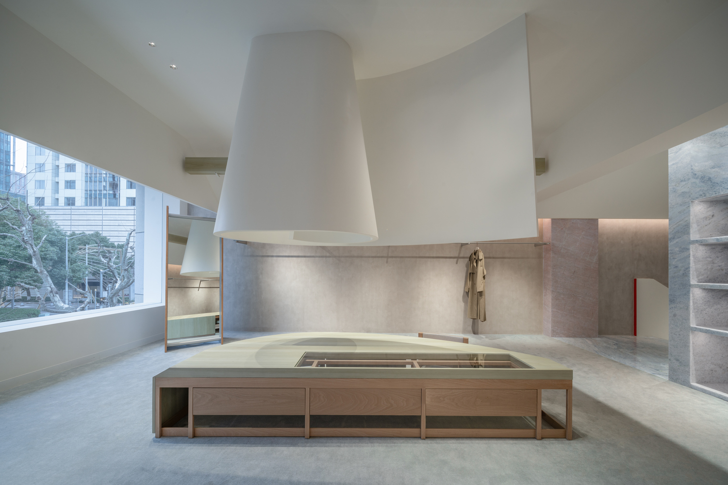 Interior view of a sunken bath with timber surround beneath a white cylindrical hood