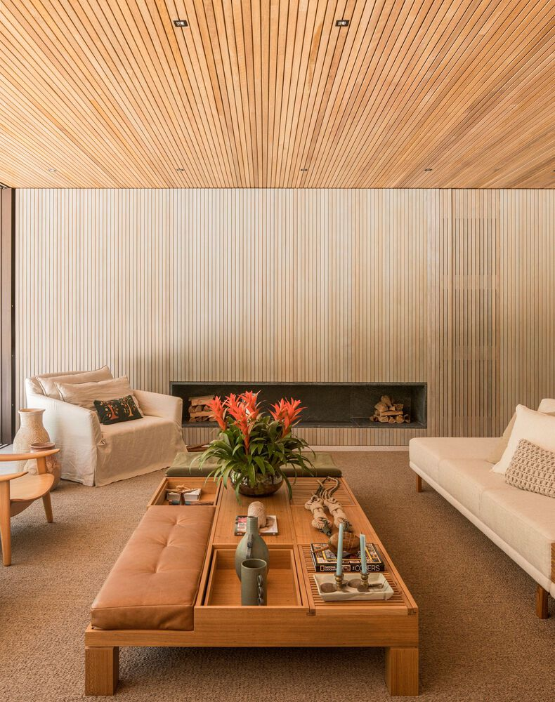 Living room: tufted leather daybed, white sofas, timber coffee table, built-in linear fireplace, timber wall and ceiling panelling