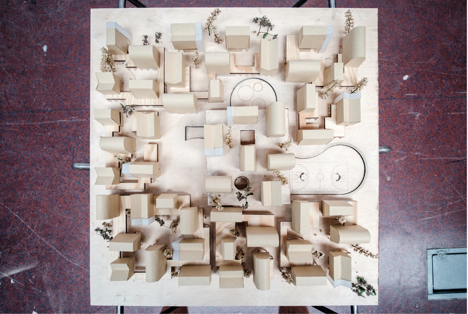 A cross-section diagram highlighting the integration of retail spaces, a marketplace, and community workshops.