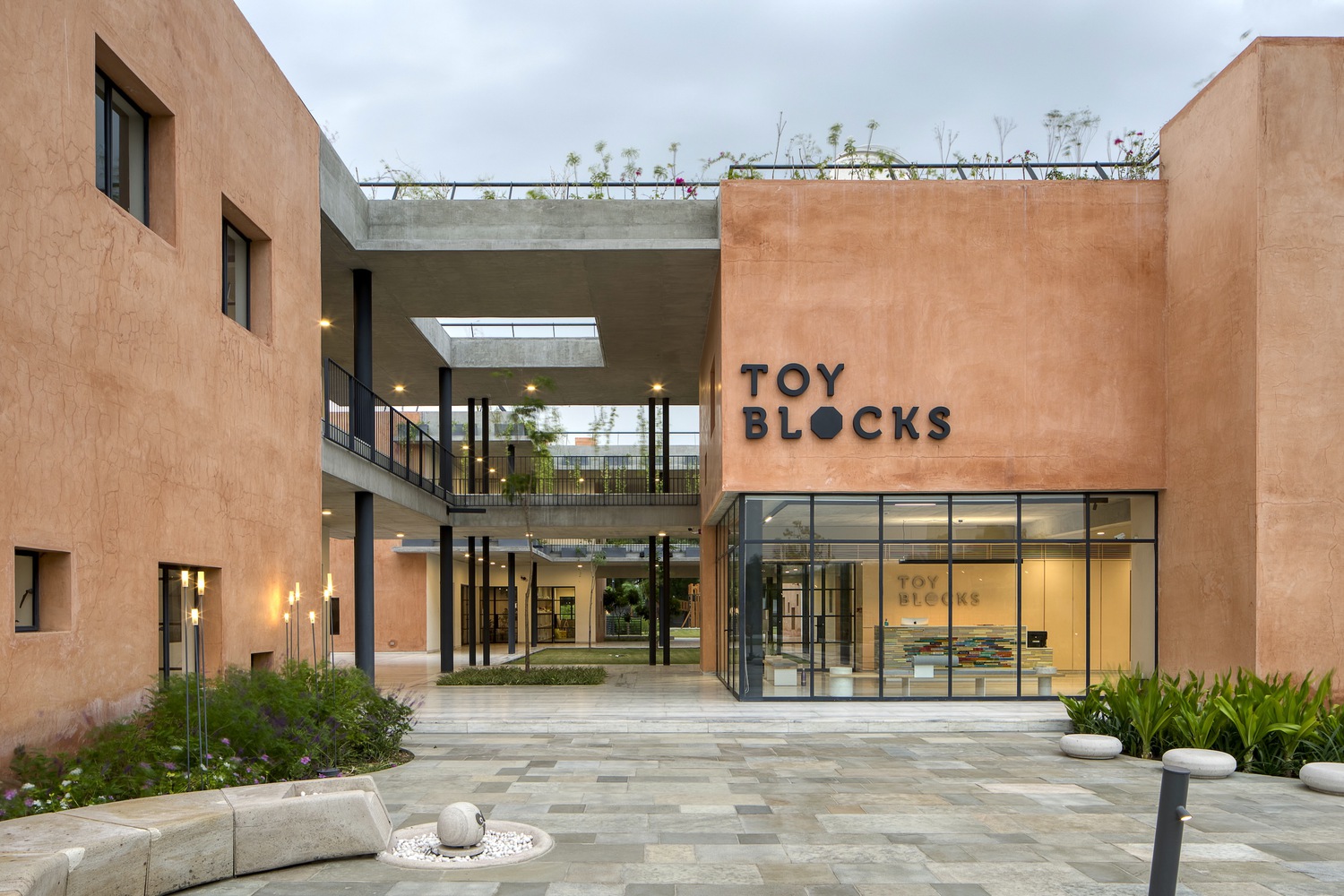 Toy Blocks Kindergarten — colourful interlocking volumes that make the Reggio Emilia philosophy spatial