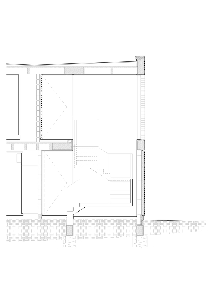Wall section detail: brick construction, concrete slab, stair void, and foundation