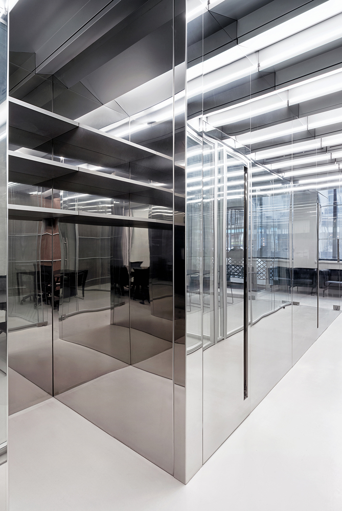 Glass corridor: stainless steel mullions receding in perspective, multiple reflections, monochrome