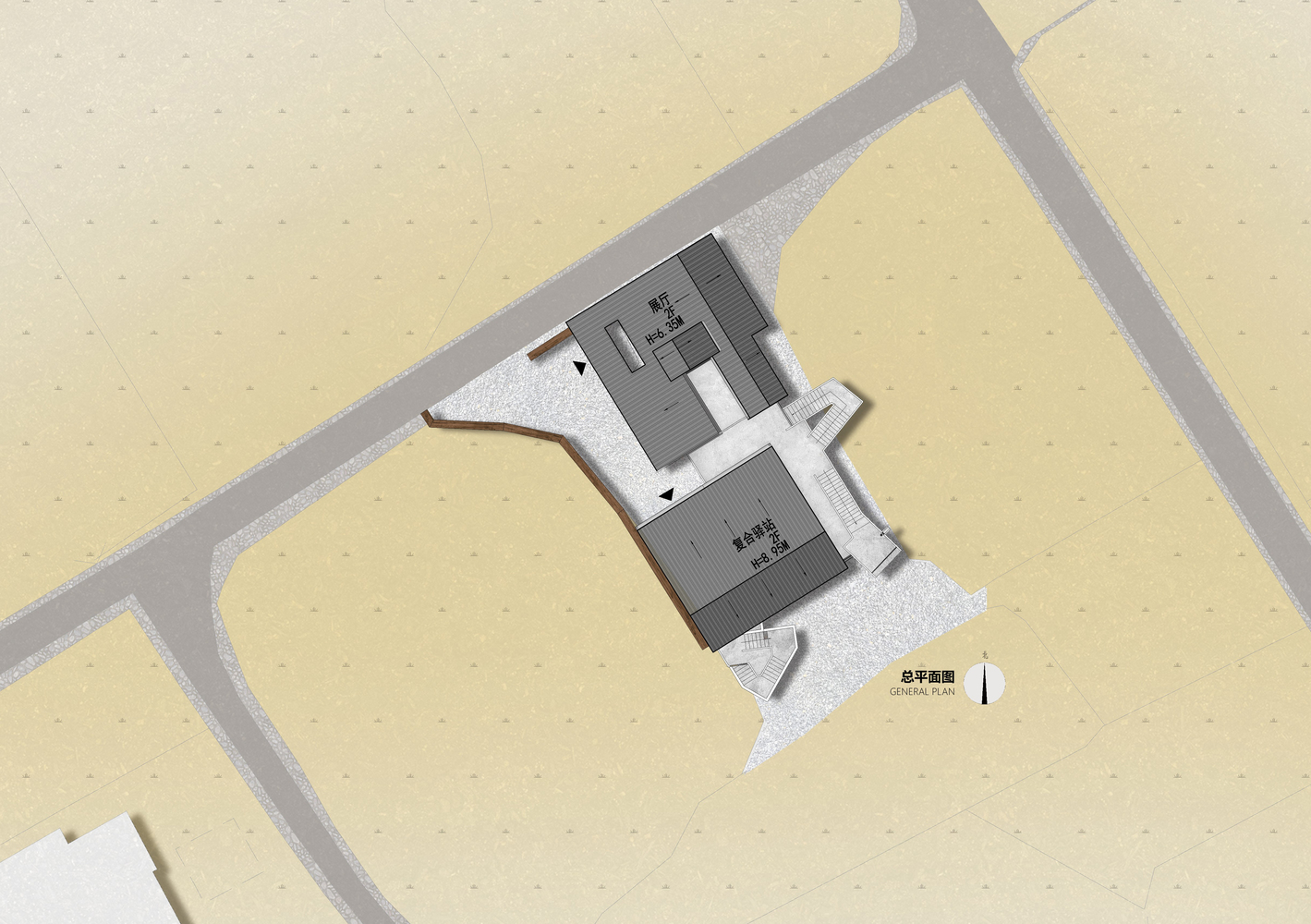 Site plan drawing showing two connected rectangular volumes surrounded by pathways and gravel surfaces
