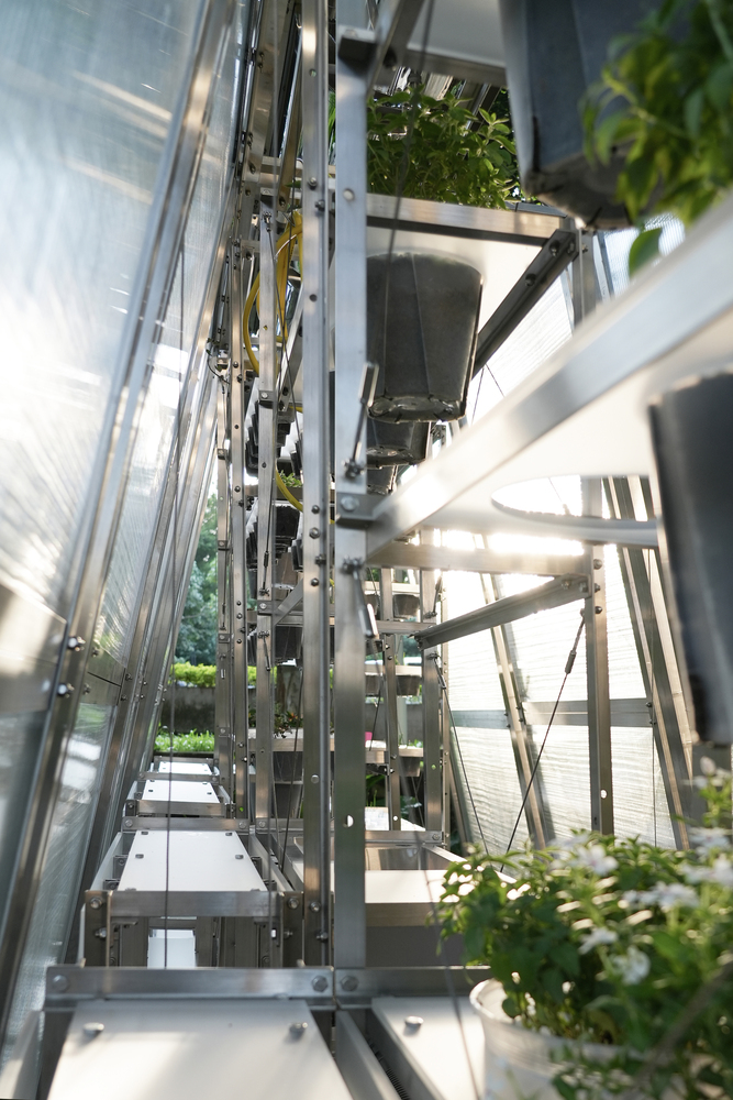 Vertical view up through the central core of the aluminum frame with planted shelves on either side