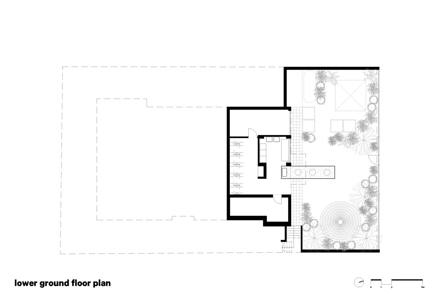 Lower ground floor plan showing rooms along one edge and courtyard garden with circular paving pattern
