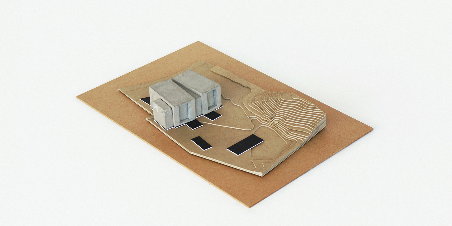 Physical model from opposite angle revealing concrete structures and contoured landscape surface