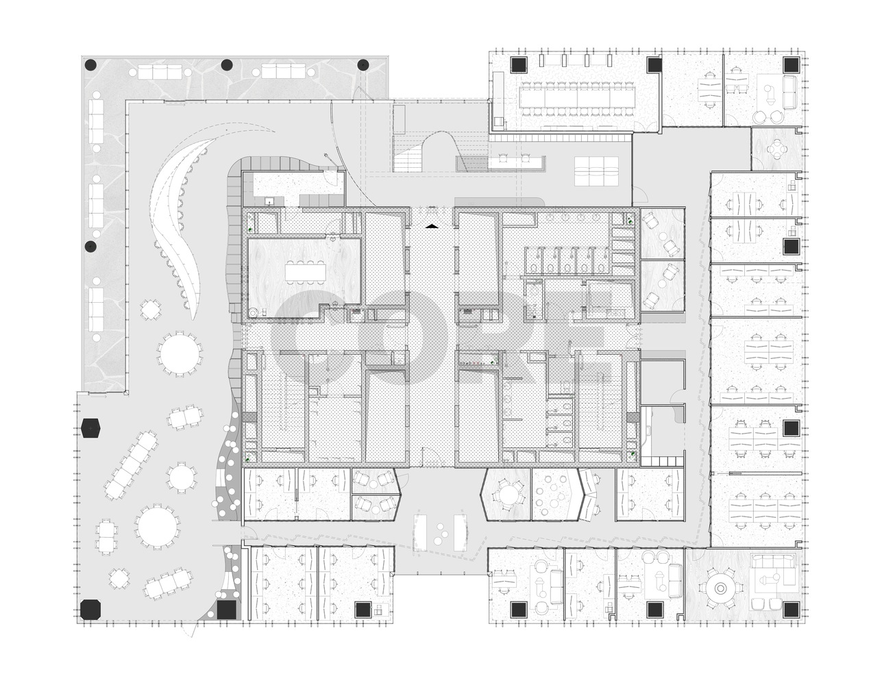 Floor plan drawing showing curved central staircase and scattered workstations within an irregular perimeter with outdoor terrace