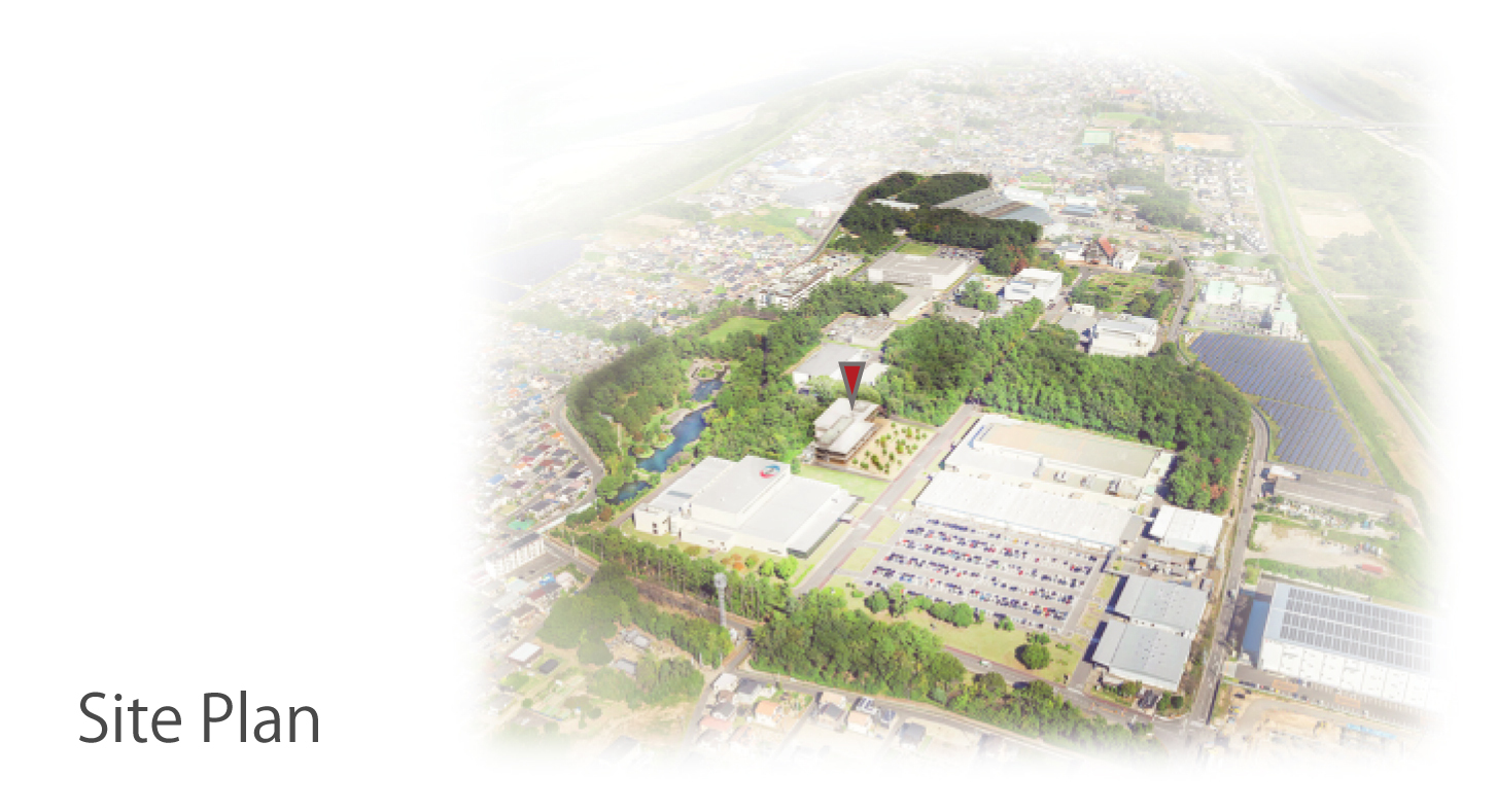 Site plan rendering illustrating the building complex with green spaces and adjacent urban fabric in soft focus