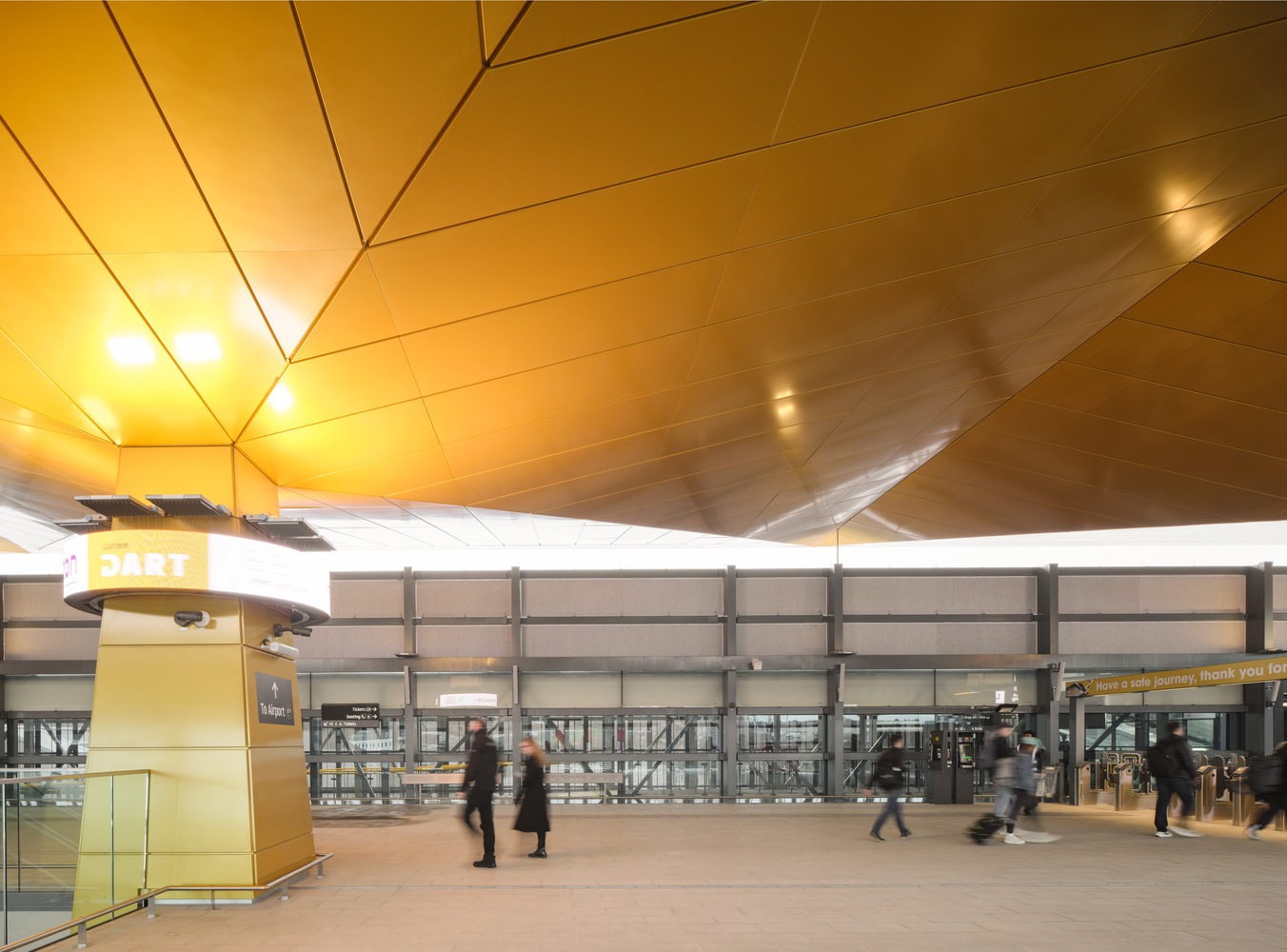 Upper concourse with angular timber ceiling planes meeting at a central fold line