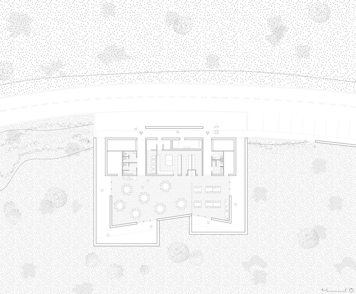 Site plan drawing showing rectangular volumes arranged around a central courtyard with trees