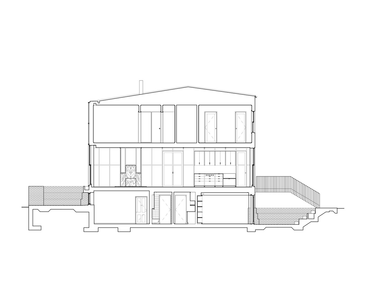 Section drawing showing a three-level residence with basement, ground floor kitchen and upper bedrooms