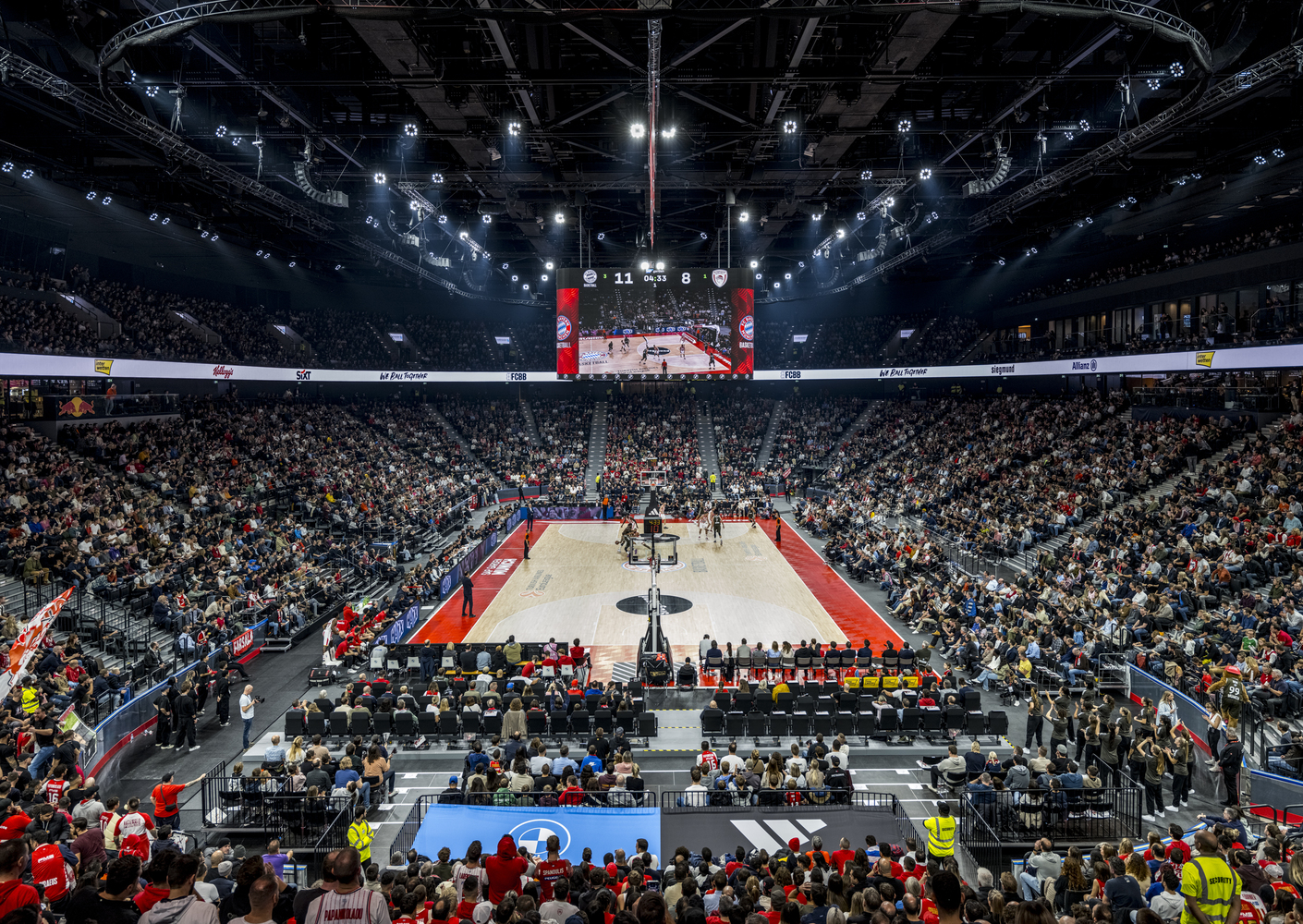 Interior view of the multipurpose arena with tiered seating and central court surrounded by spectators