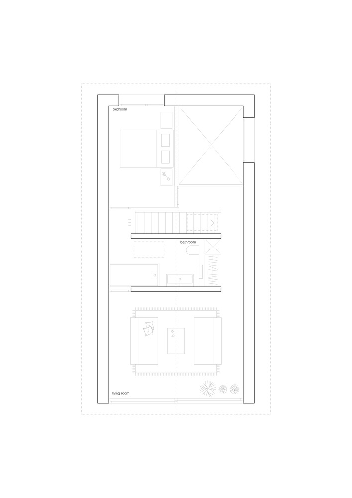Top floor plan drawing showing bedroom and living room spaces with a central stair and balcony
