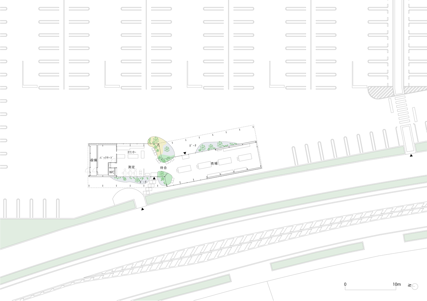 Site plan drawing showing angled building footprint between parking lots and diagonal railway tracks