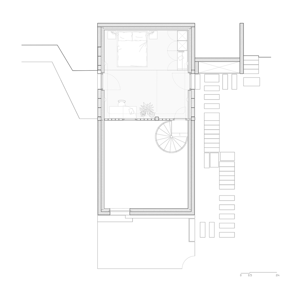 Floor plan drawing showing bedroom level with spiral stair connecting to adjacent exterior stairs