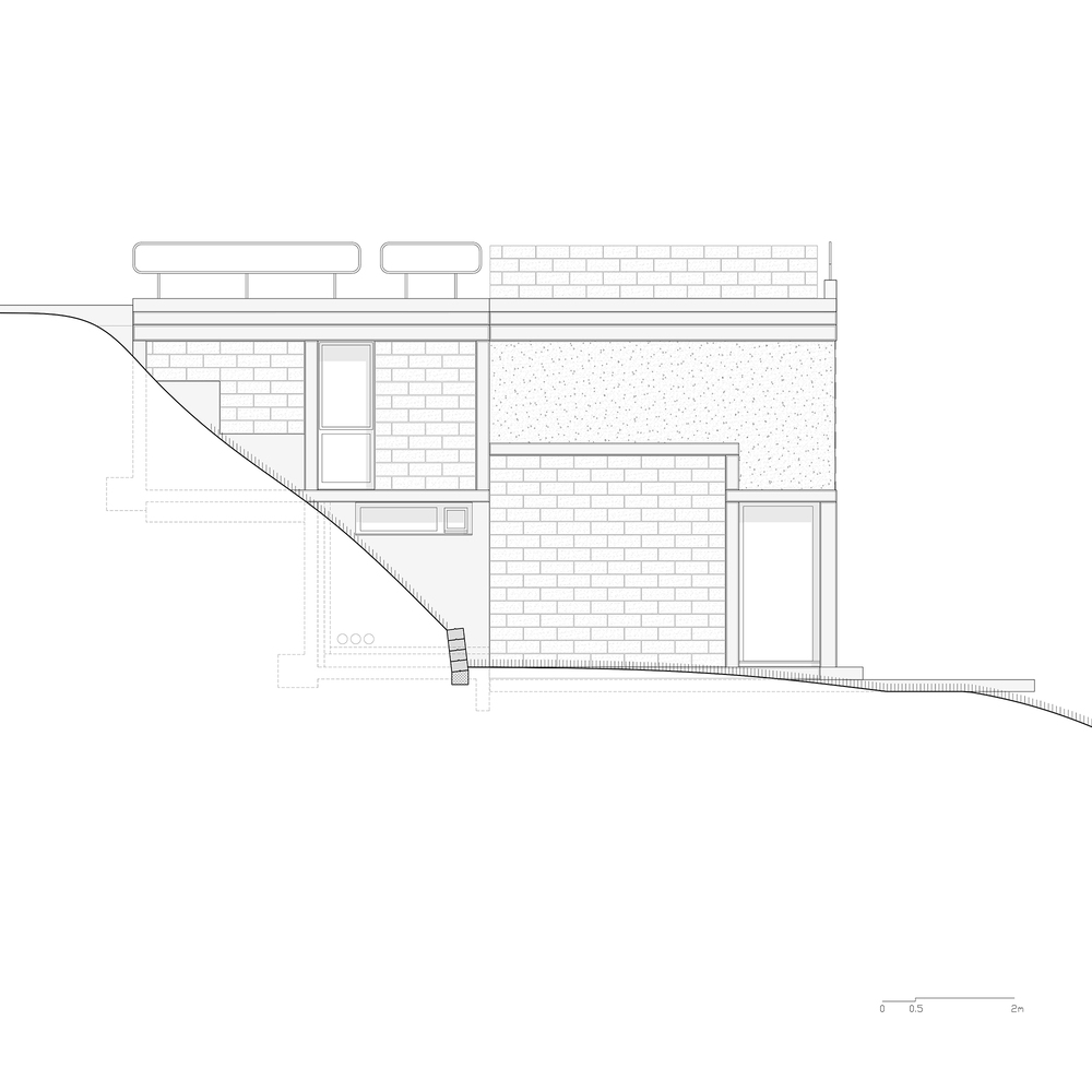 Elevation drawing depicting brick facade with windows on sloping terrain