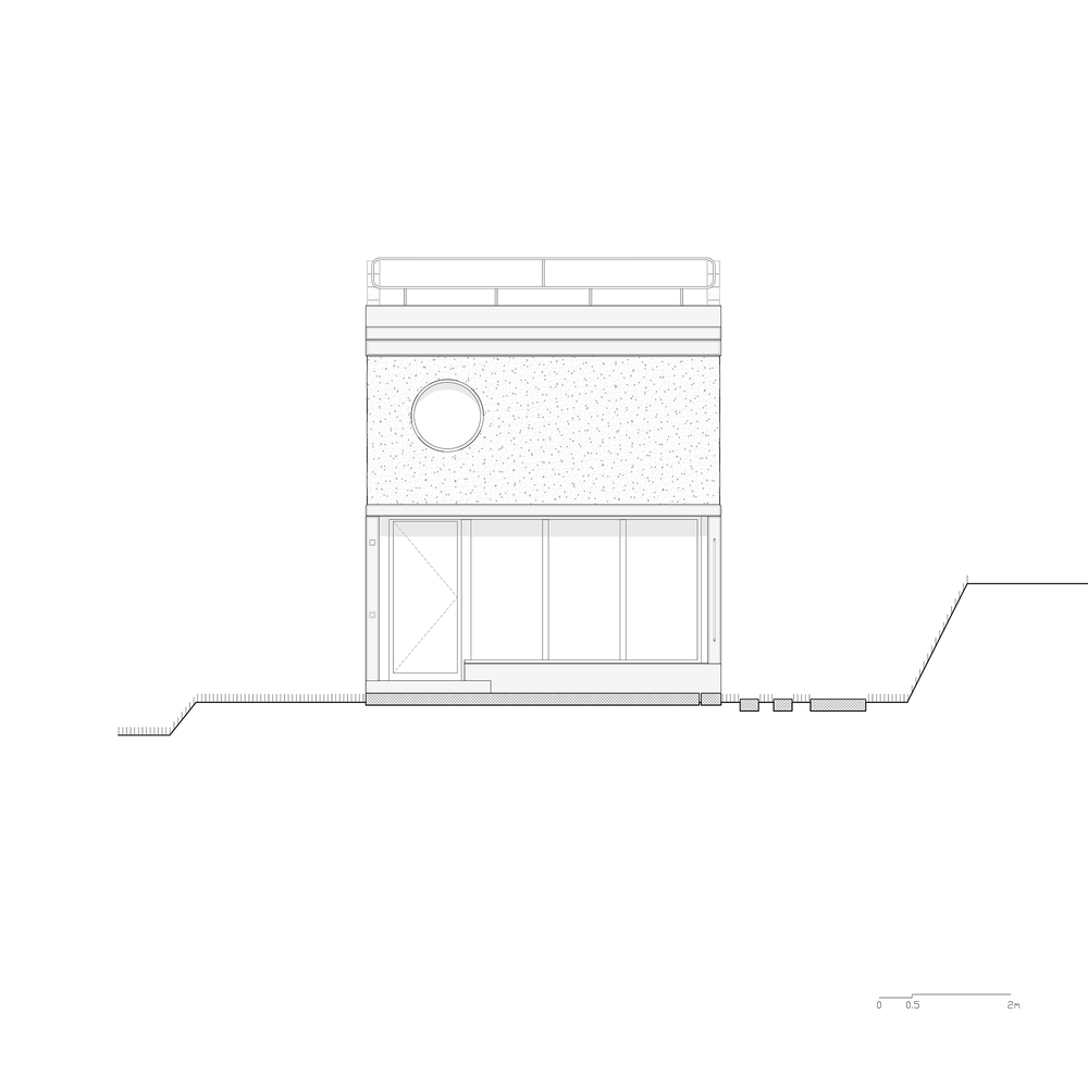Front elevation drawing showing textured wall panel with circular window above glazed base