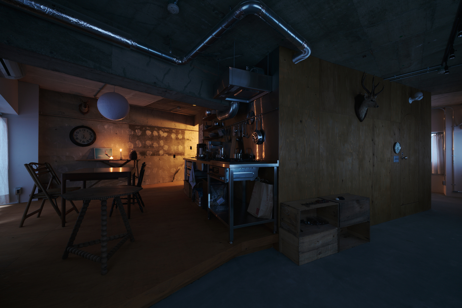 Open living space with dining table and kitchen island at dusk with minimal artificial light