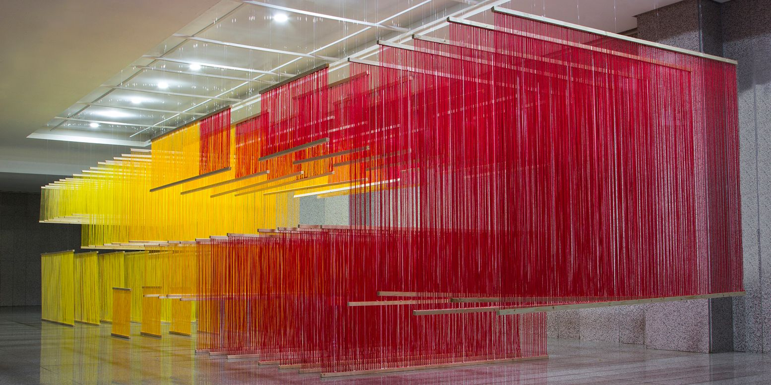 Long view of the gradient thread installation spanning from yellow to red across the interior