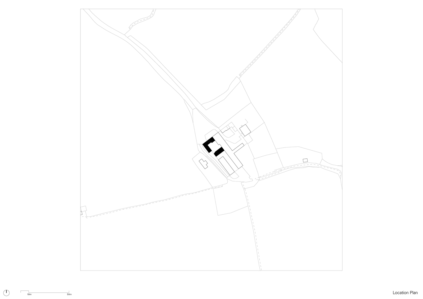 Site plan drawing showing building cluster positioned between converging roadways and landscape contours