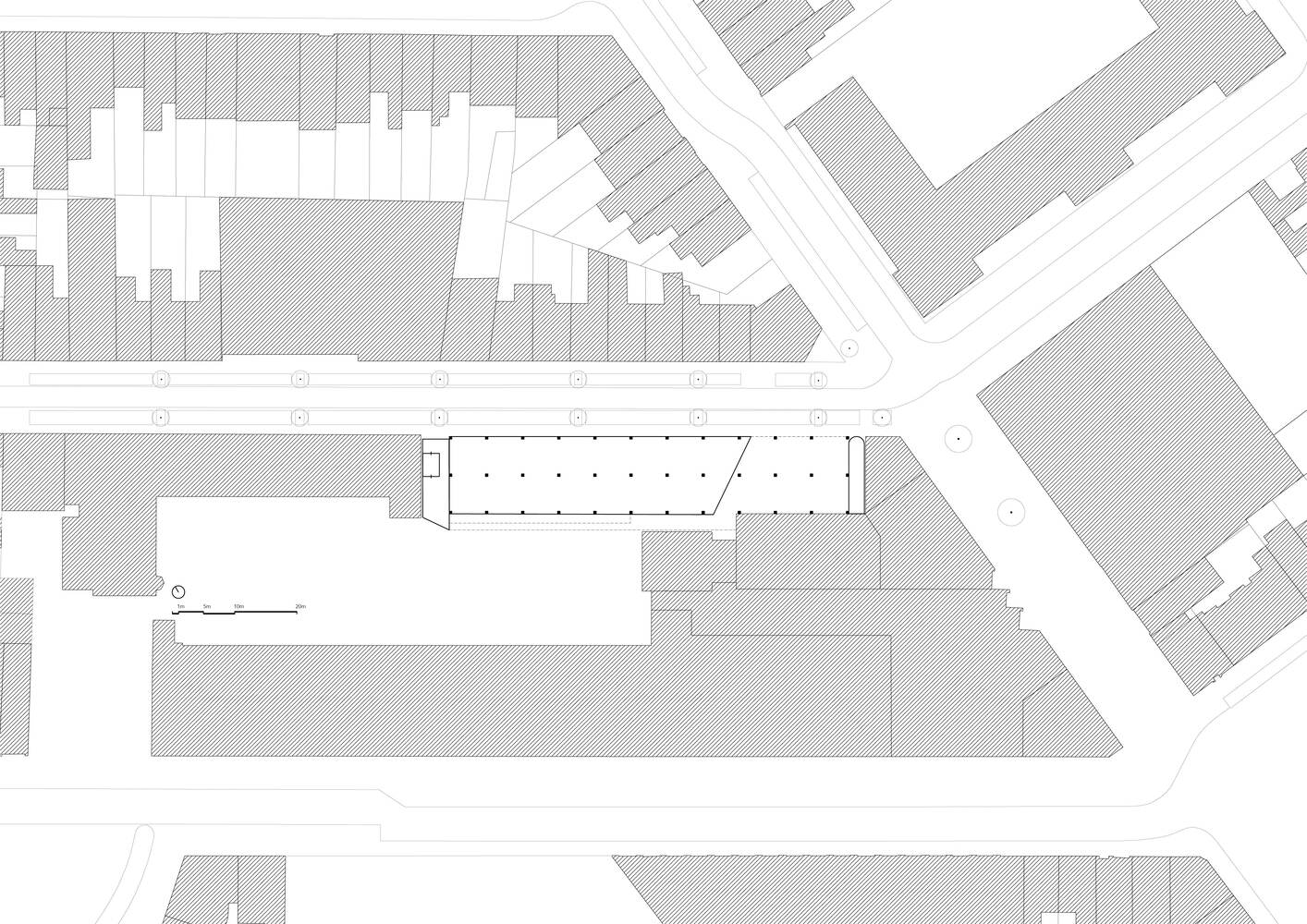 Site plan drawing showing the elongated rectangular building footprint within the surrounding urban block context