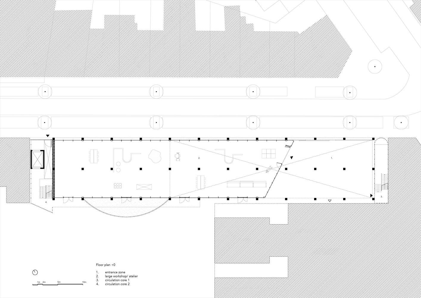 Floor plan drawing showing the open interior layout with diagonal staircase and perimeter column grid