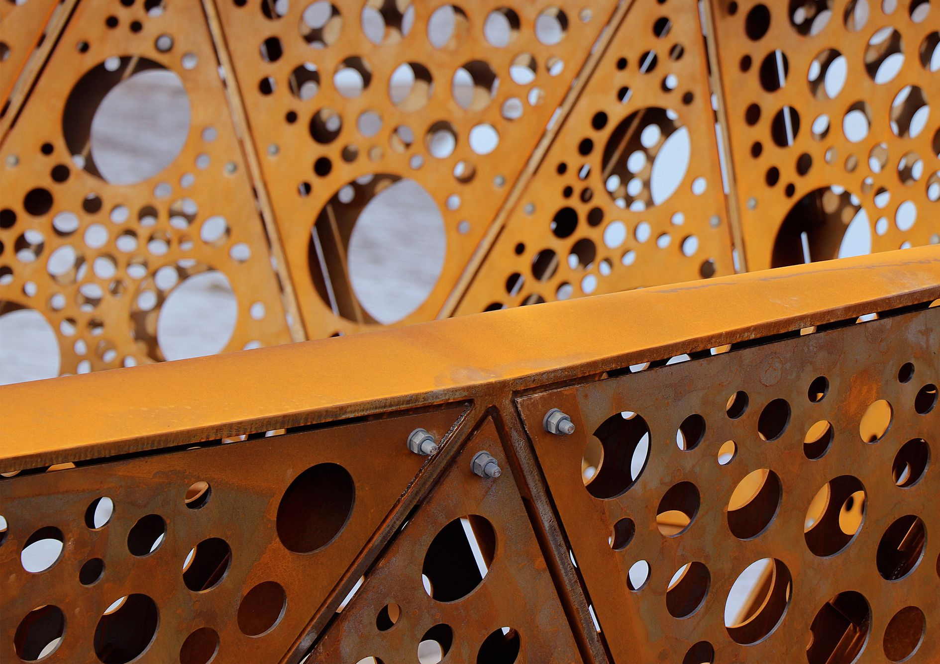Intricate perforated steel panels form the unique design of Greatham Creek Seal Hide, blending modern architecture with nature.
