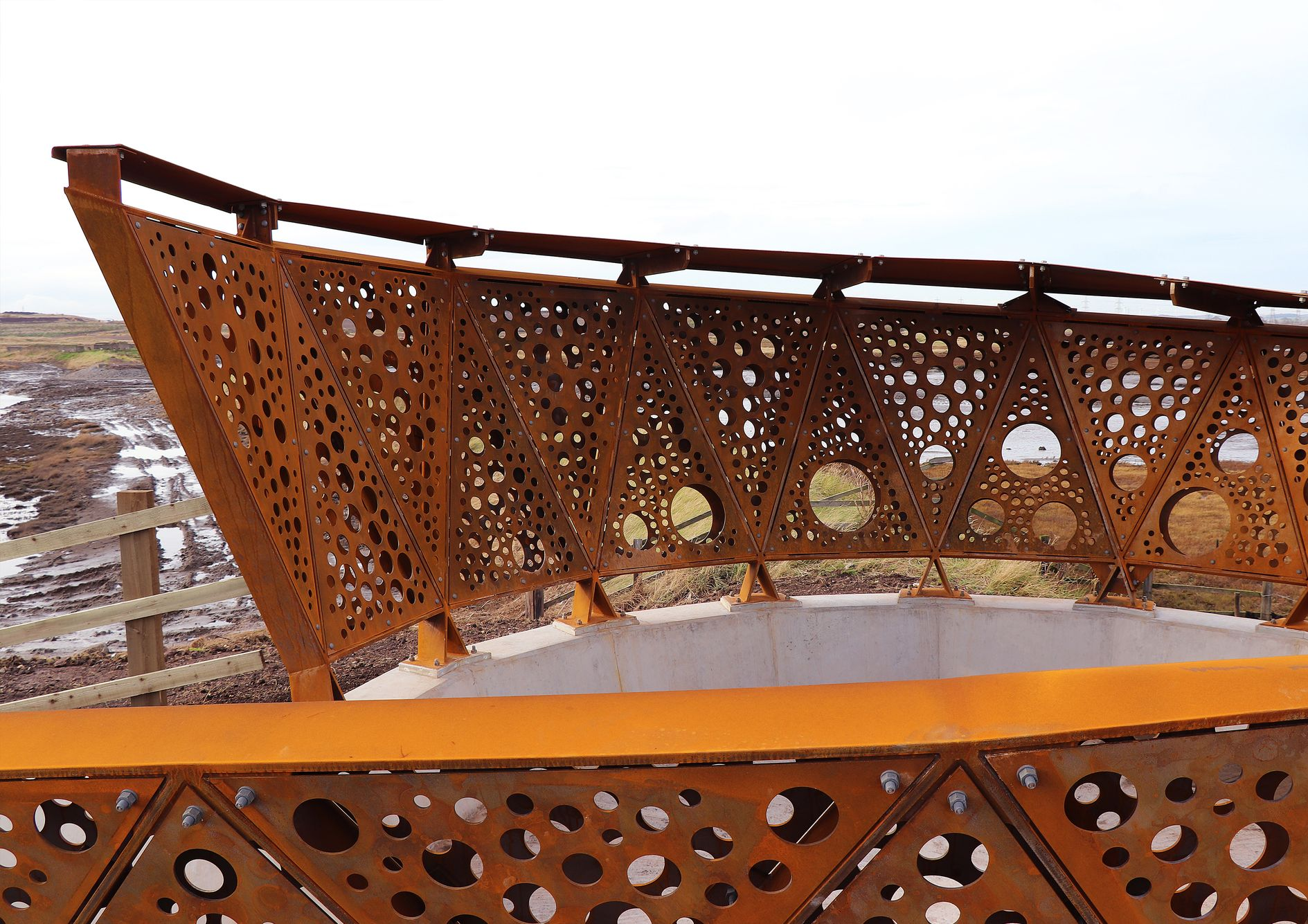 Geometric steel panels of Greatham Creek Seal Hide create a unique visual experience, blending seamlessly with the wetland environment.