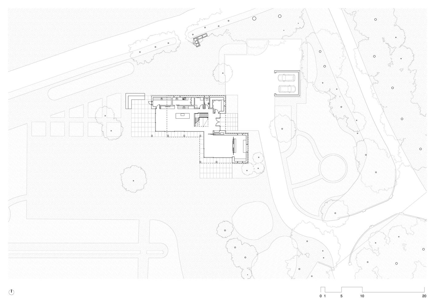 Site plan drawing showing house and garage positioned among existing trees and landscape contours