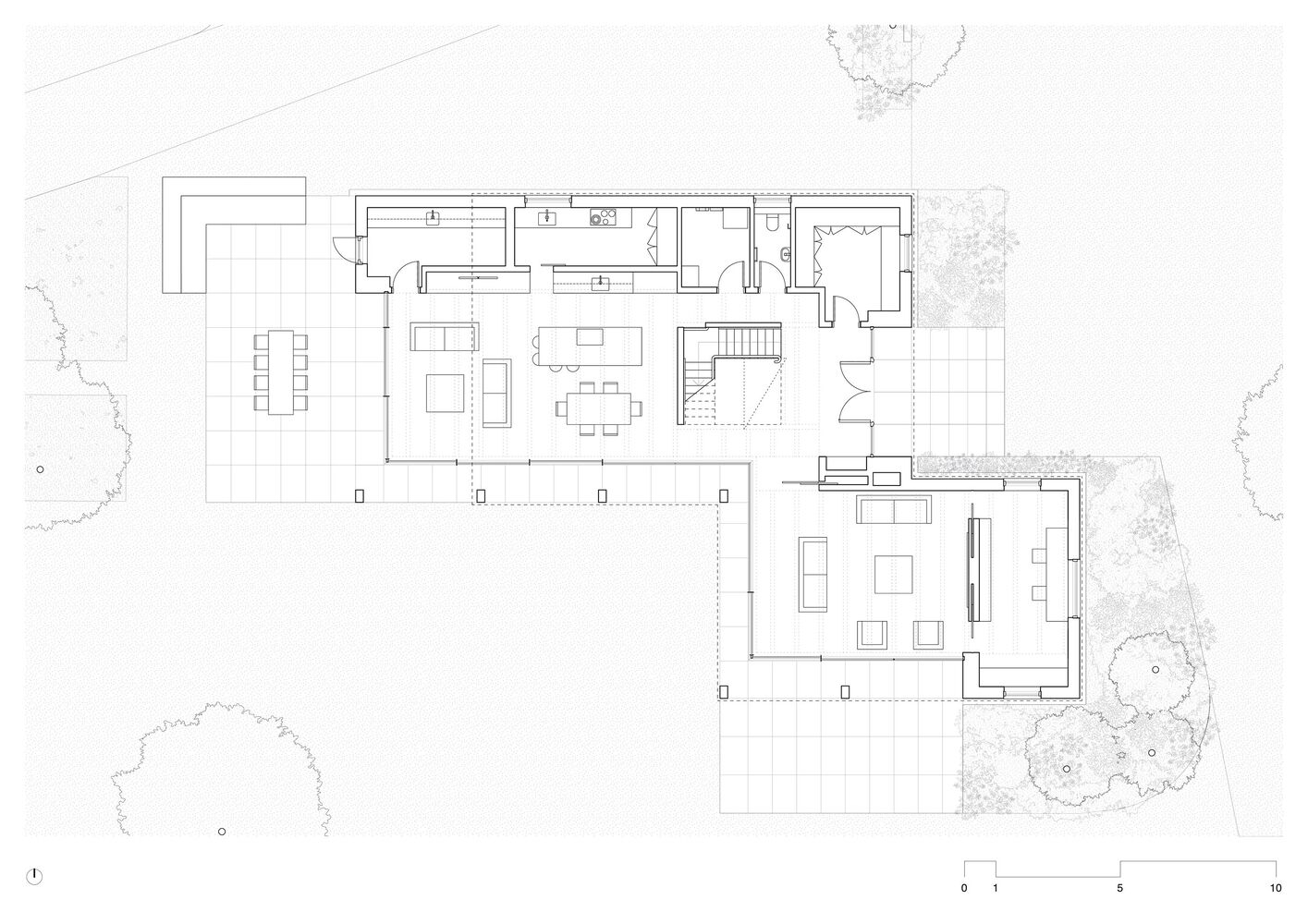 Floor plan drawing showing two connected volumes with living spaces and a central staircase surrounded by landscaping