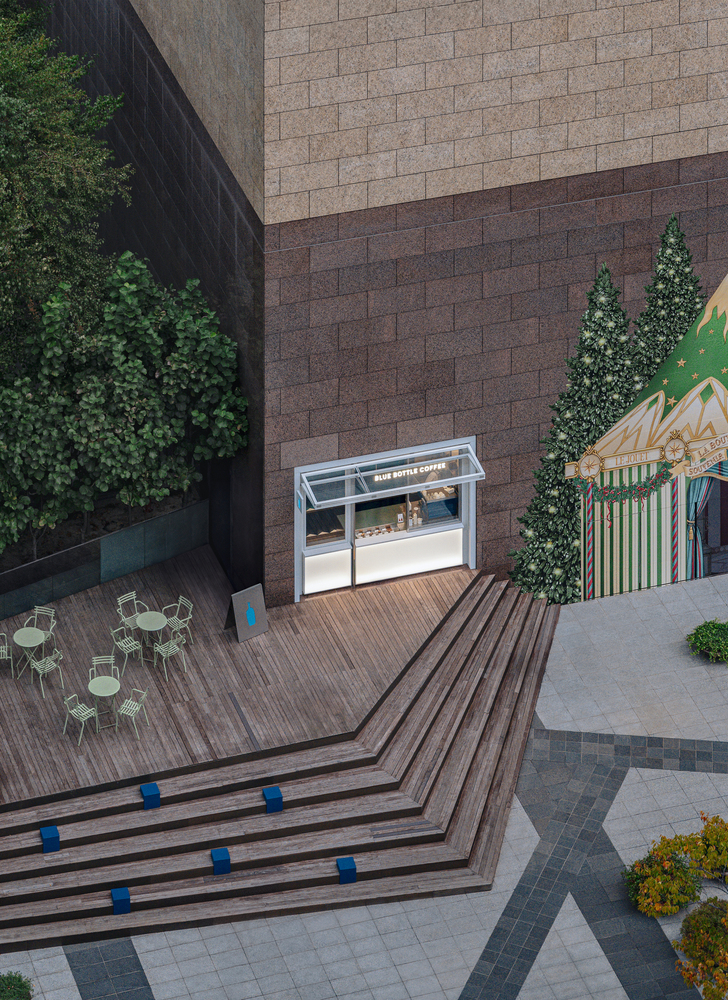 Aerial view of timber deck terraces with blue cube accents beside outdoor seating area