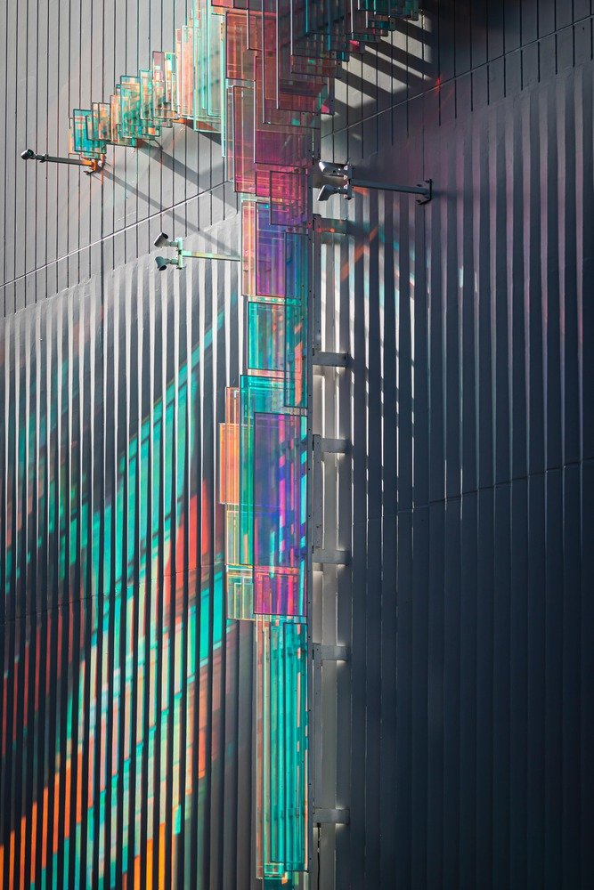 Close-up of the dichroic glass cross and external staircase on the vertical louvered facade