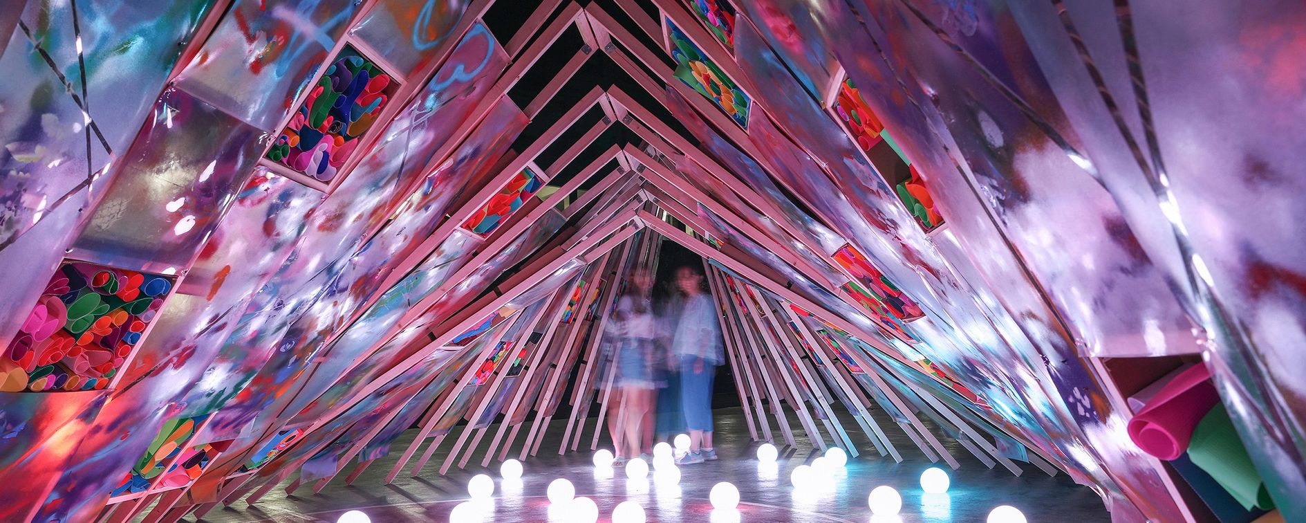 Inside the colorful and creative space of Hi Ladders High, where light, art, and architecture blend together under the night sky.