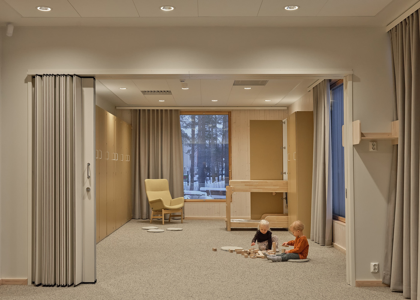 Same room with two children playing on the carpet beneath the timber bunk bed
