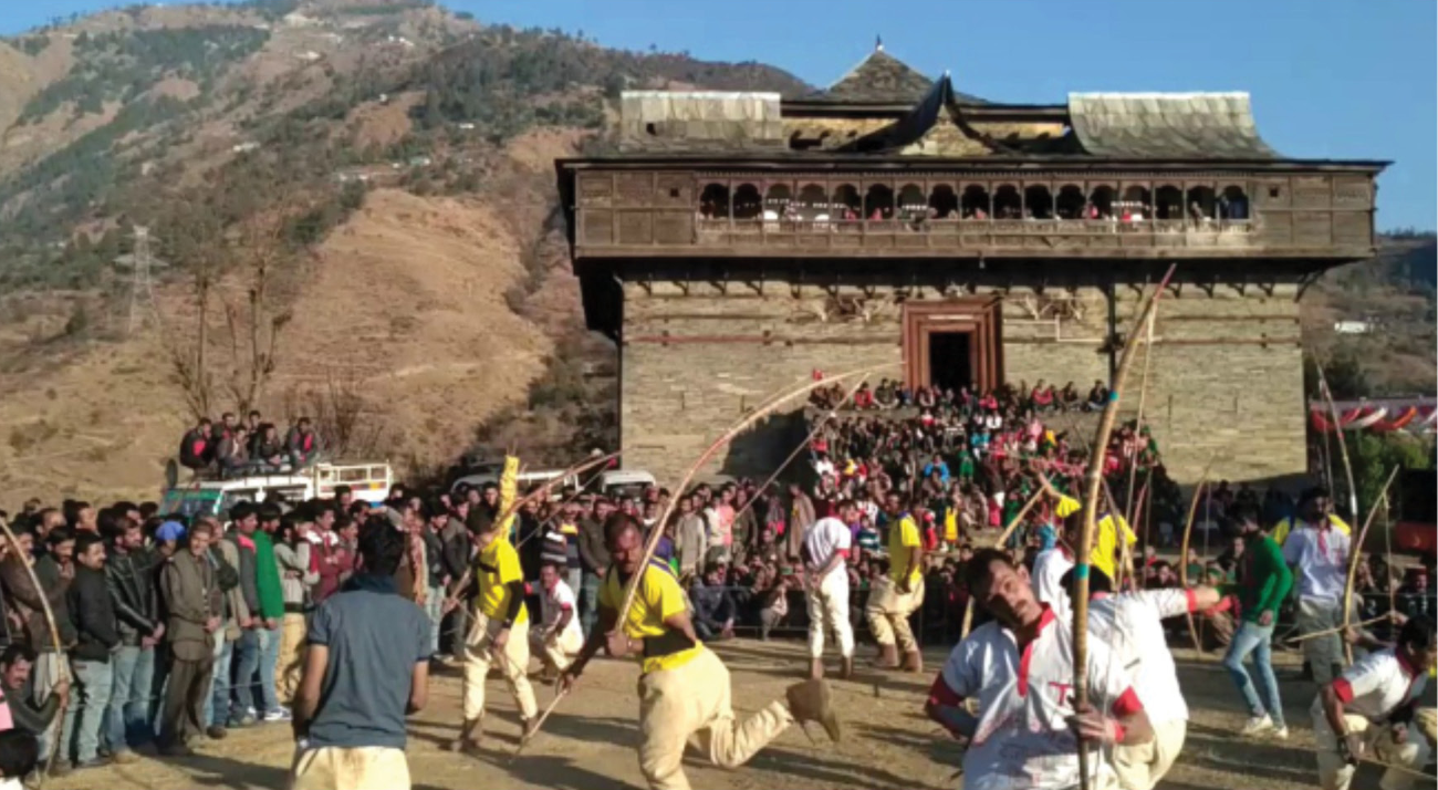 Vibrant cultural festivities unfolding around traditional built forms.